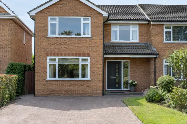 Integral garage converted to a room with a new window set in matching brickwork