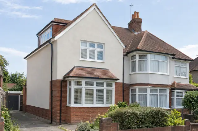 1930s semi with a hip-to-gable loft conversion showing a new rendered gable wall