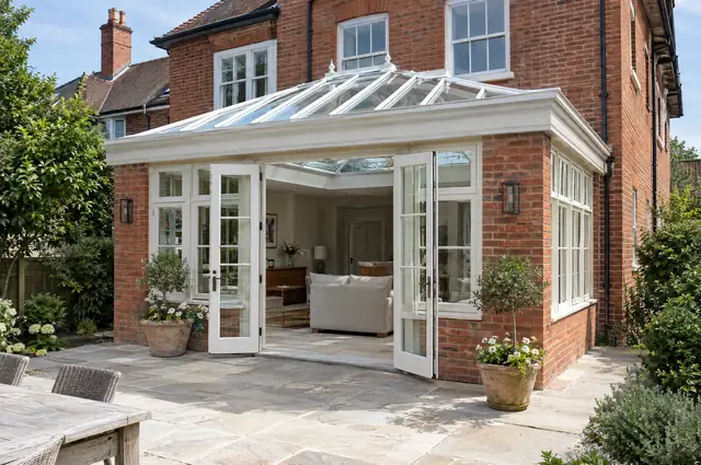 Brick-pier orangery with glazed lantern roof and French doors on an Edwardian house