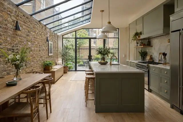 Victorian terrace side return extension with a long glazed roof and exposed brick wall
